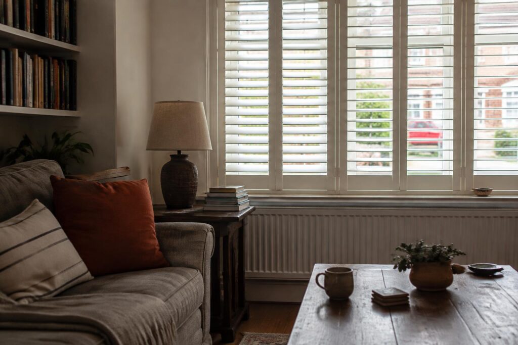 Living room shutters adding privacy and a finished look to a relaxed UK sitting room